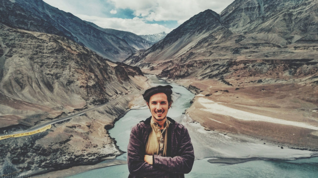 A man with mountains in the background