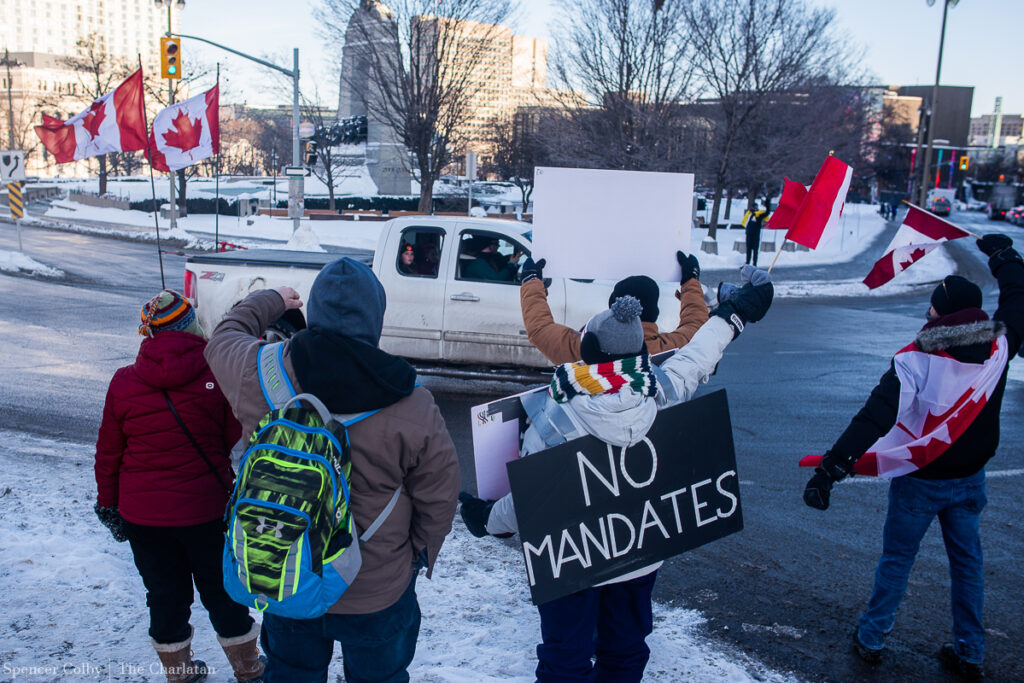 Protestors cheer on a convoy on Friday, Jan. 28, 2022 ahead of a 'Trucker Convoy 2022' anti-vaccination protest on Jan. 29.