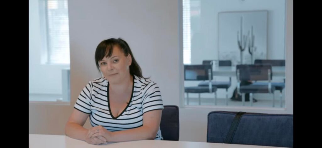 Tori Stafford, editor-in-chief of Kingstonist News, looks into the camera from behind her desk.