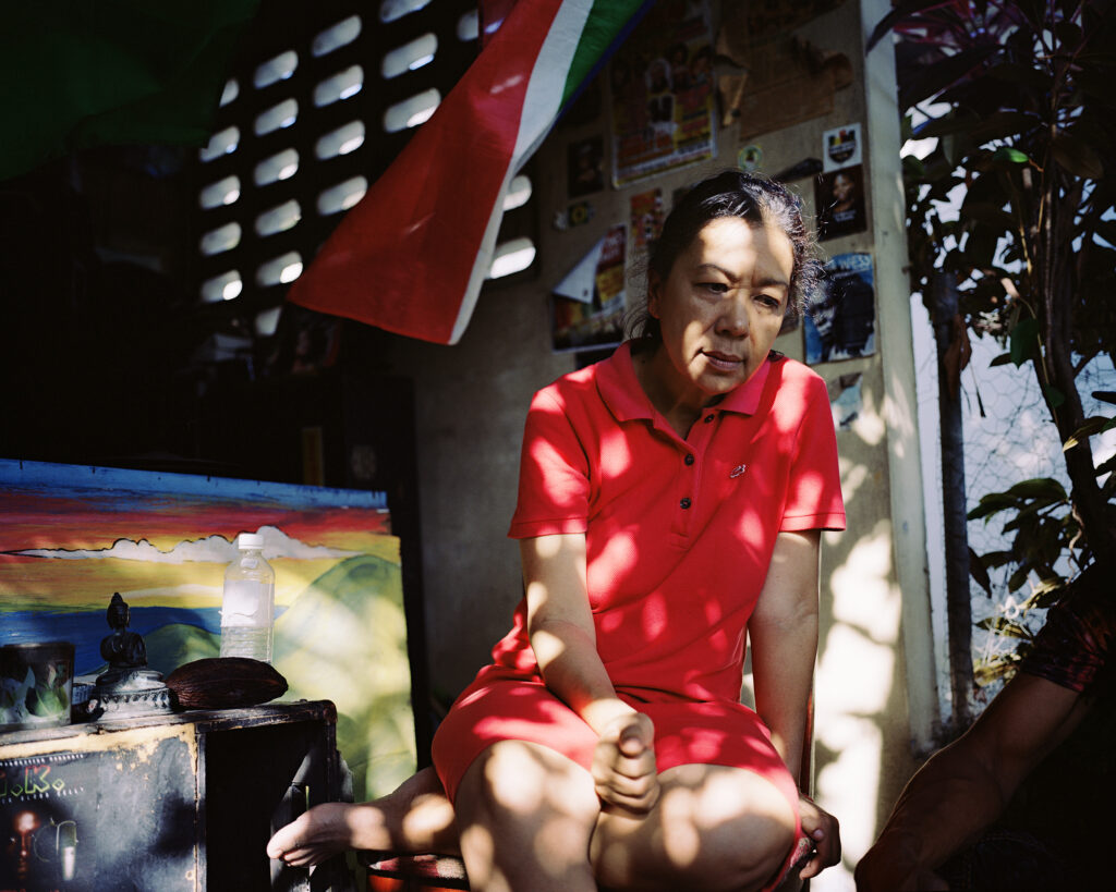 A portrait of a woman in a red dress in Kingson, Jamaica.