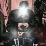 Hockey player surrounded by mics in a locker room.