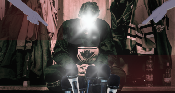 Hockey player surrounded by mics in a locker room.