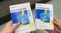 A photo of two copies of the UNHCR's journalism guide.