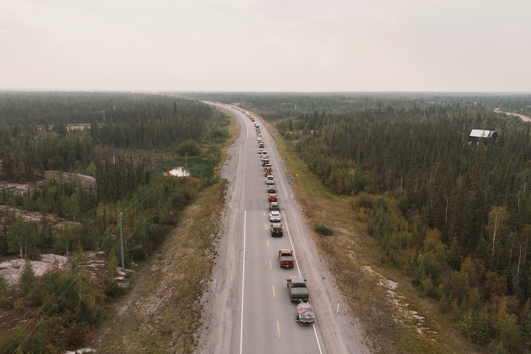 Residents flee Yellowknife on Highway 3 after being ordered to evacuate on August 16, 2023, due to a wildfire burning closer to the city 