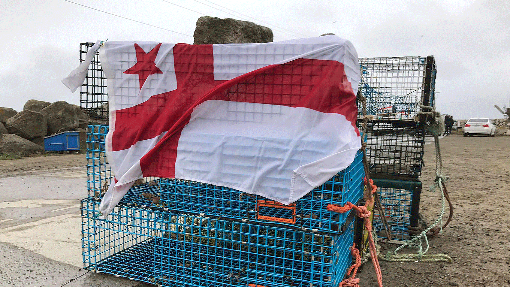 A Mi’kmaq First Nation flag draped over lobster traps in Nova Scotia. Photo: Angel Moore / courtesy APTN