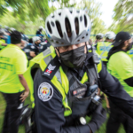 Blurry image of a police officer looking into the camera.