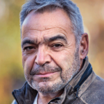 Julian Sher looks at the camera in a portrait photo