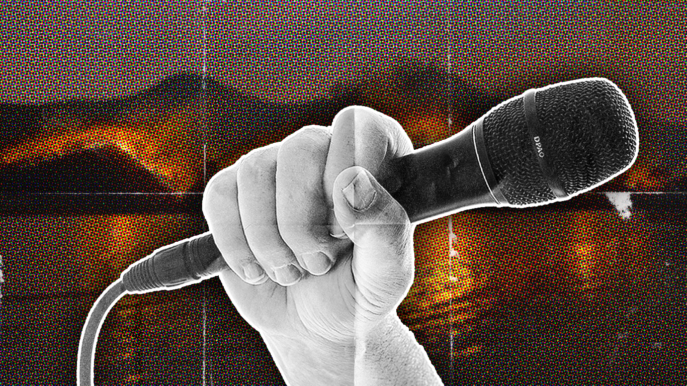 An illustration of a white hand holding a black microphone in front a background with a forest on fire surrounded by water in the background.